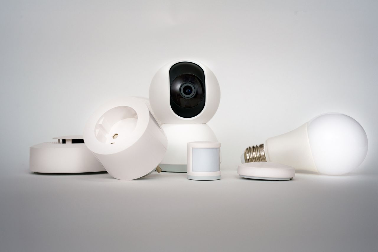 About A range of smart home devices including camera and lightbulb in a minimalist setup.