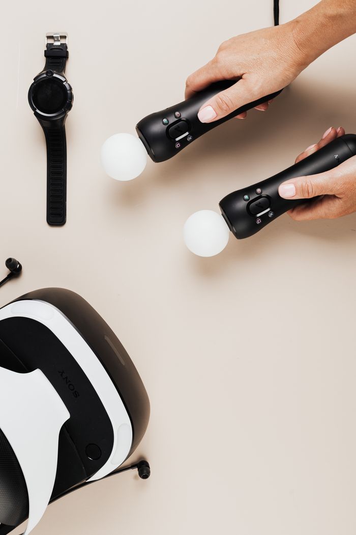 Crafting Captivating Headlines: Your awesome post title goes here Hands holding VR controllers next to a headset. Perfect for tech enthusiasts.