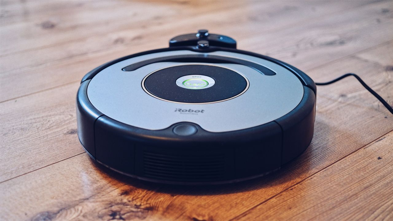 about-img Close-up of a robotic vacuum cleaner operating on a hardwood floor, showcasing modern cleaning technology.